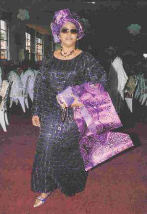 A photograph of a woman in African dress