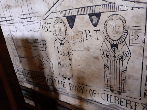 A medieval church tomb inscribed HERE LIETH BURIED THE BODY OF GILBERT